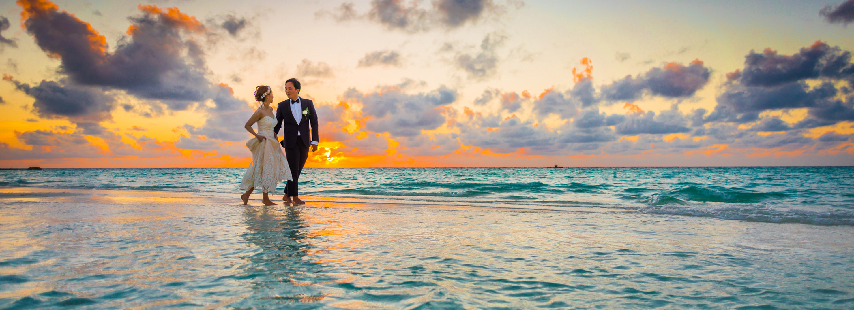 bride and groom on shoreline